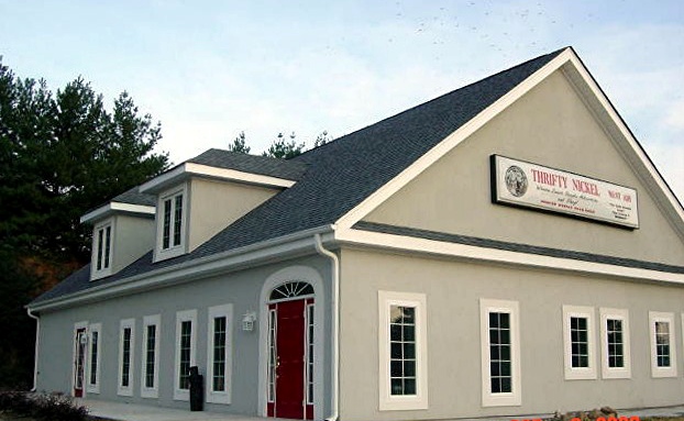 Beige storefront building with red door
