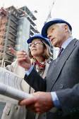 Professionals reviewing plans at construction site